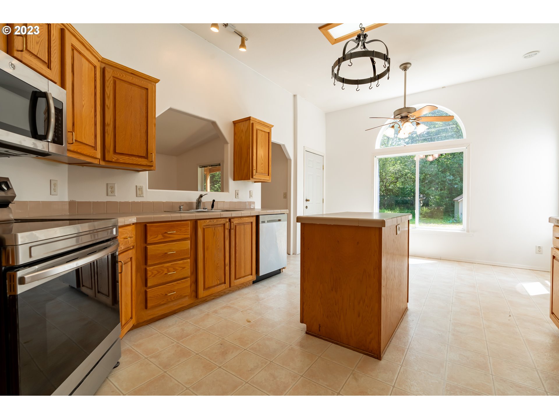 60929 Highway 26 Sandy, OR 97055 - Photo 17 of 38 a kitchen with kitchen island granite countertop a sink cabinets and window