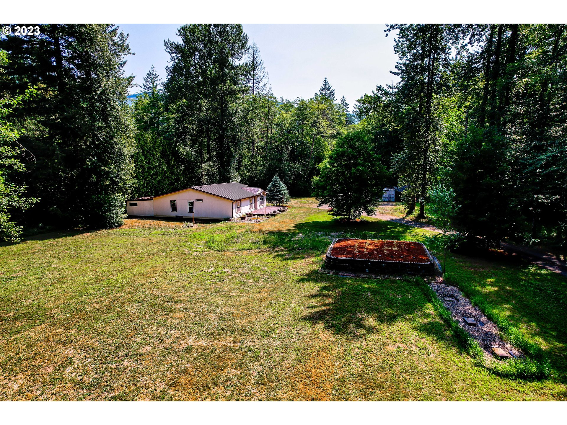 60929 Highway 26 Sandy, OR 97055 - Photo 7 of 38 a view of a backyard with swimming pool