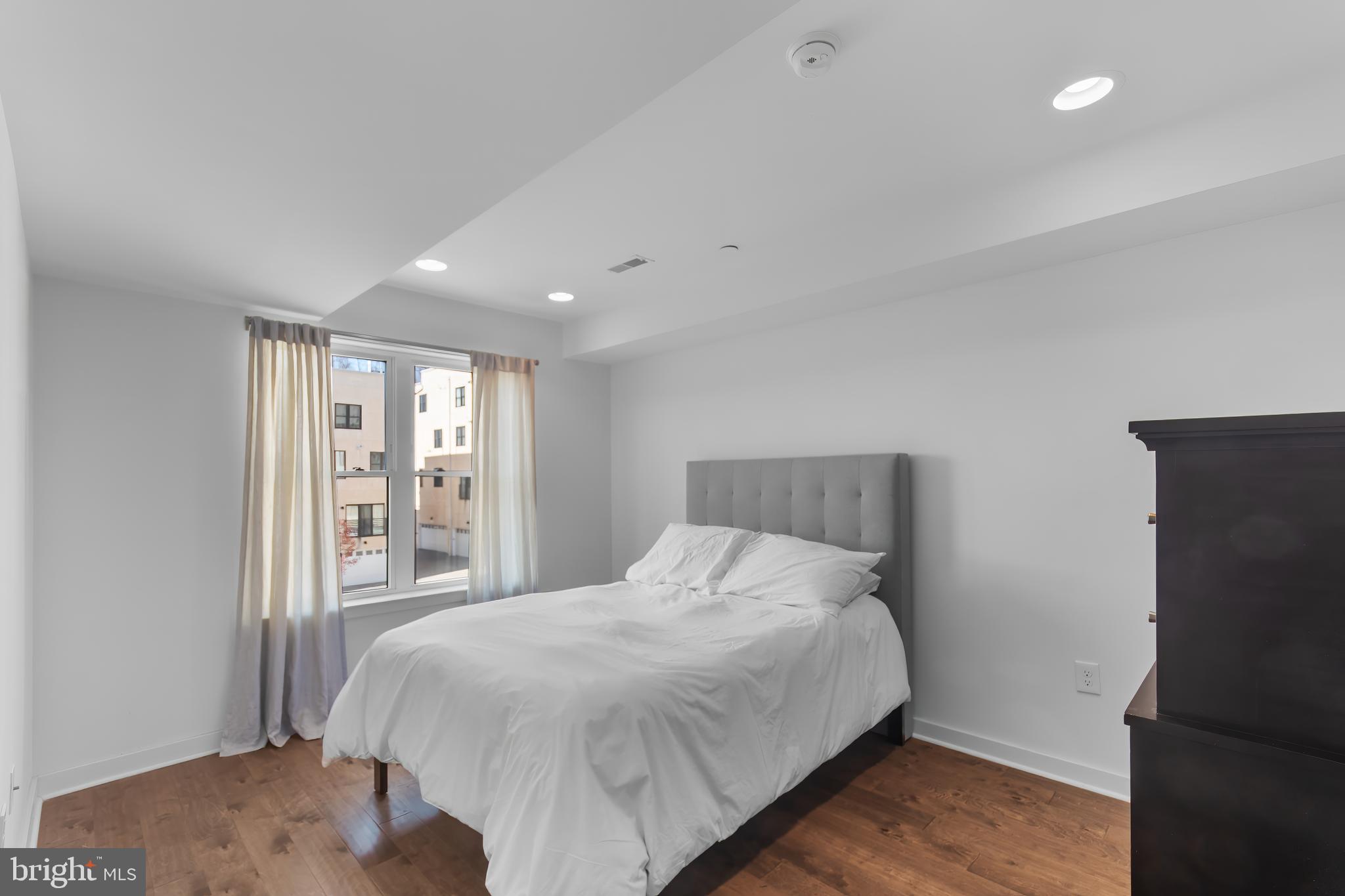 136 Burnside Street Philadelphia, PA 19127 - Photo 13 of 25 a large bed sitting in a bedroom next to a window