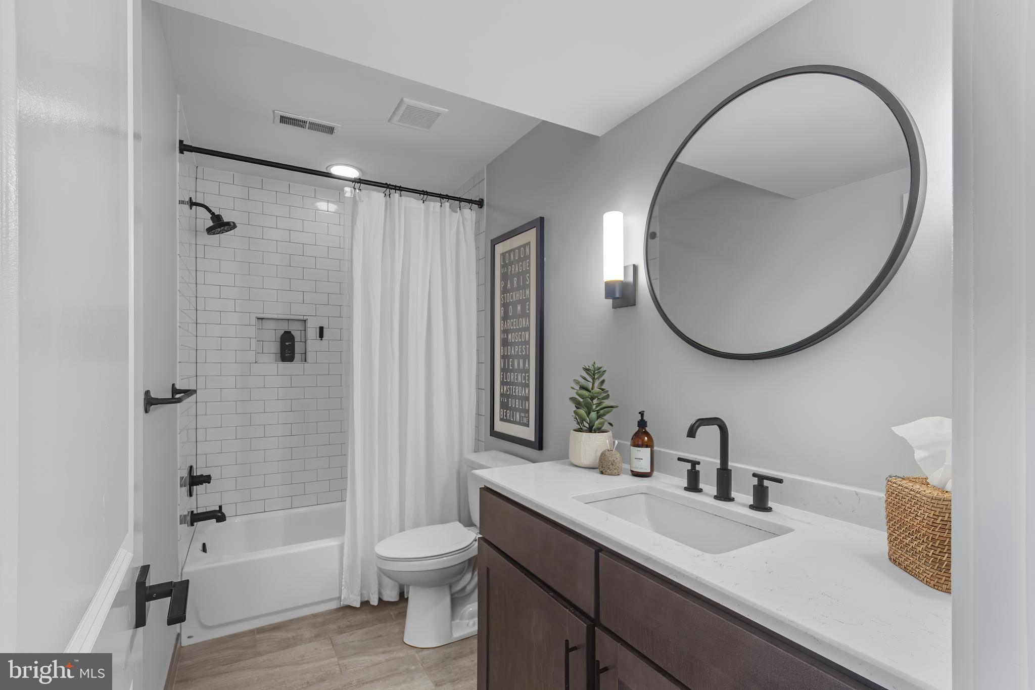 136 Burnside Street Philadelphia, PA 19127 - Photo 14 of 25 a bathroom with a sink a toilet and a mirror
