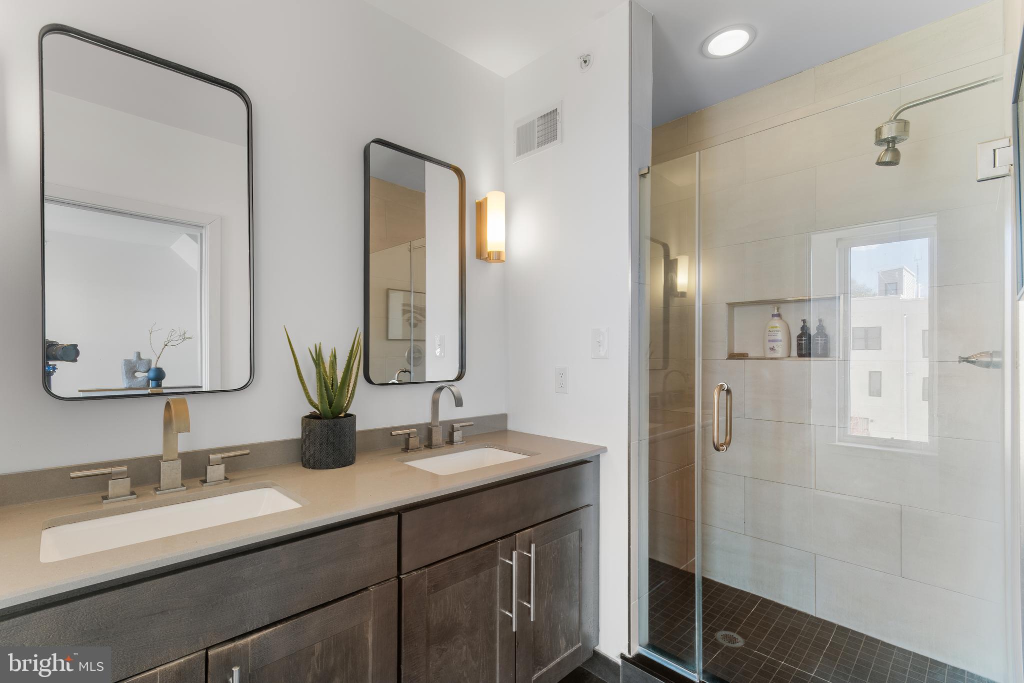 136 Burnside Street Philadelphia, PA 19127 - Photo 17 of 25 a bathroom with double vanity sinks and a mirror