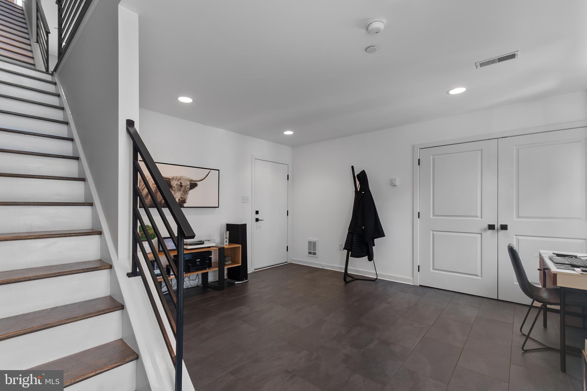136 Burnside Street Philadelphia, PA 19127 - Photo 3 of 25 a view of an empty room with stairs wooden floor and furniture