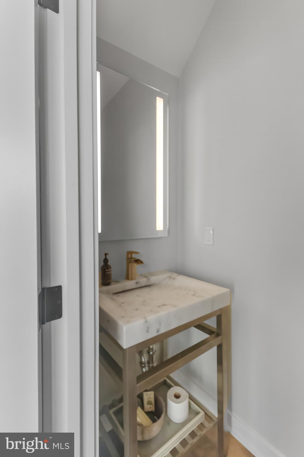 136 Burnside Street Philadelphia, PA 19127 - Photo 10 of 25 a bathroom with a sink a vanity and a mirror