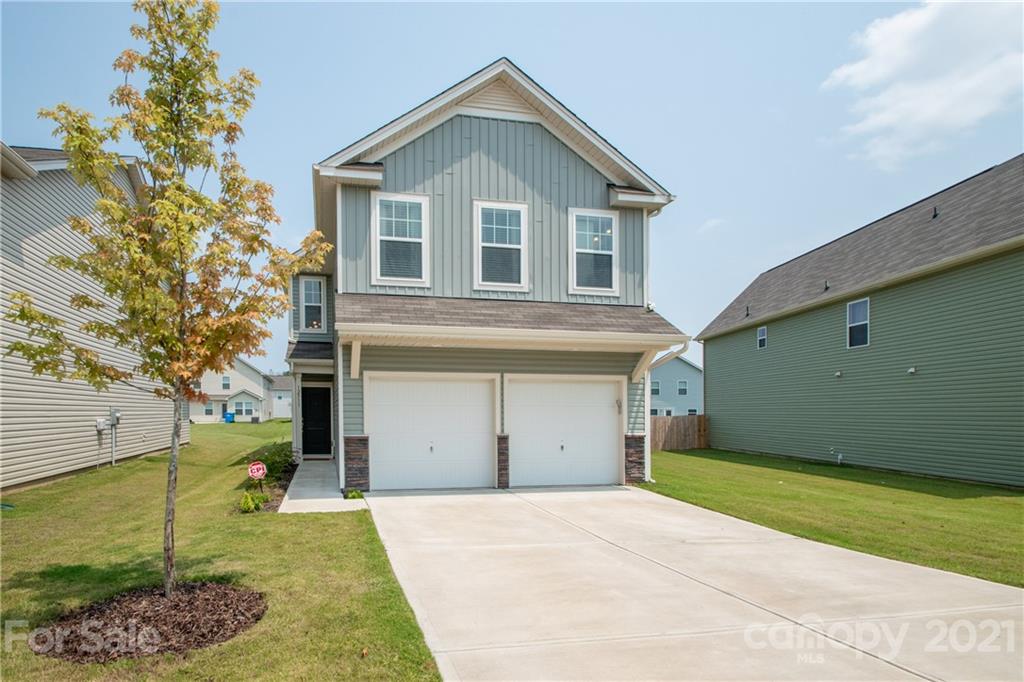 12511 Gotland Road, Unit 313 Midland, NC 28107 - Photo 1 of 31 a front view of a house with a yard and garage