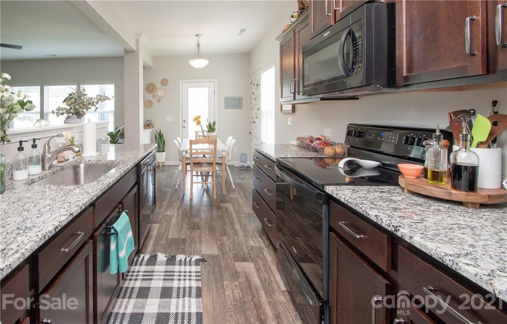 12511 Gotland Road, Unit 313 Midland, NC 28107 - Photo 11 of 31 a kitchen with granite countertop lots of counter top space and stainless steel appliances