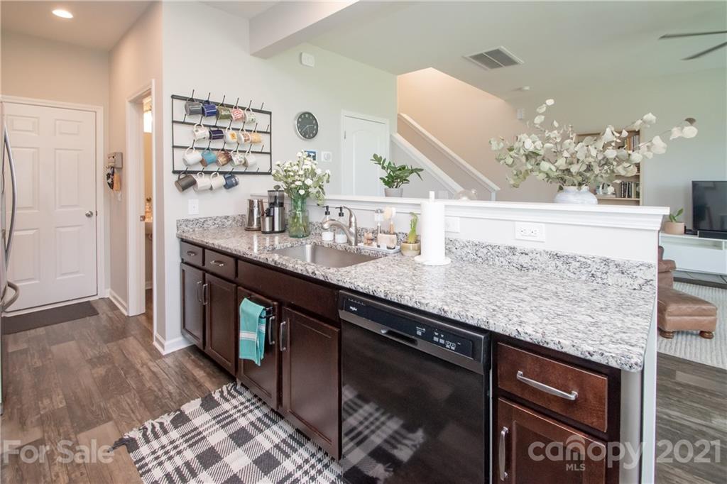 12511 Gotland Road, Unit 313 Midland, NC 28107 - Photo 12 of 31 a kitchen with stainless steel appliances granite countertop a sink stove and cabinets