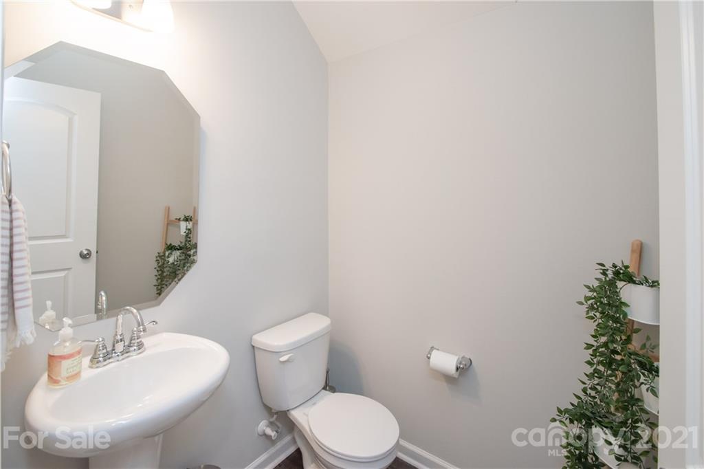 12511 Gotland Road, Unit 313 Midland, NC 28107 - Photo 16 of 31 a white toilet sitting next to a bathroom sink