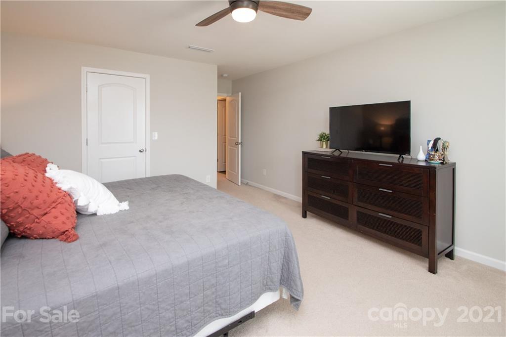 12511 Gotland Road, Unit 313 Midland, NC 28107 - Photo 19 of 31 a bedroom with a bed and a flat screen tv