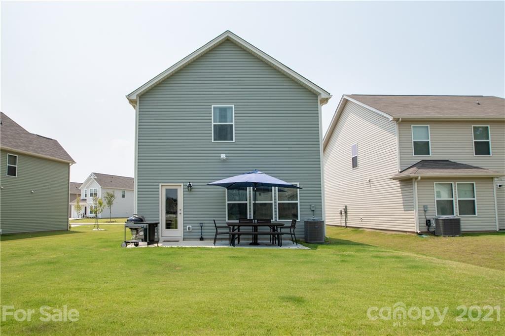 12511 Gotland Road, Unit 313 Midland, NC 28107 - Photo 3 of 31 a view of a house with a yard and sitting area