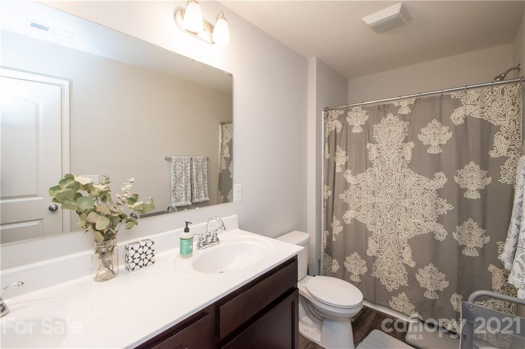 12511 Gotland Road, Unit 313 Midland, NC 28107 - Photo 27 of 31 a bathroom with a sink a toilet and a mirror