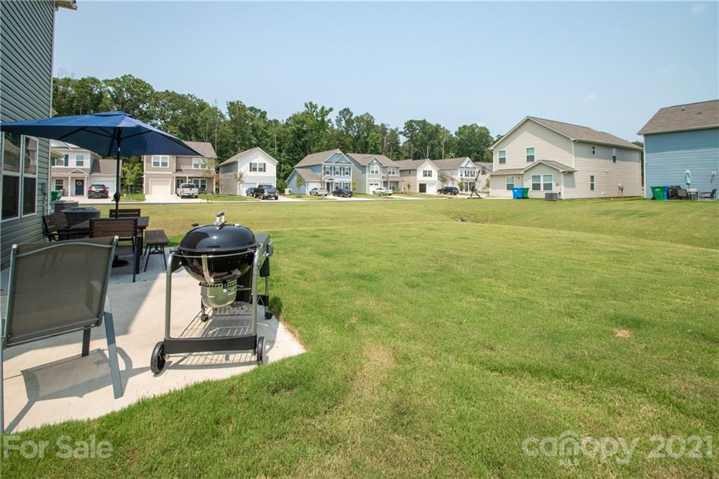 12511 Gotland Road, Unit 313 Midland, NC 28107 - Photo 30 of 31 a view of house with backyard outdoor seating and barbeque oven