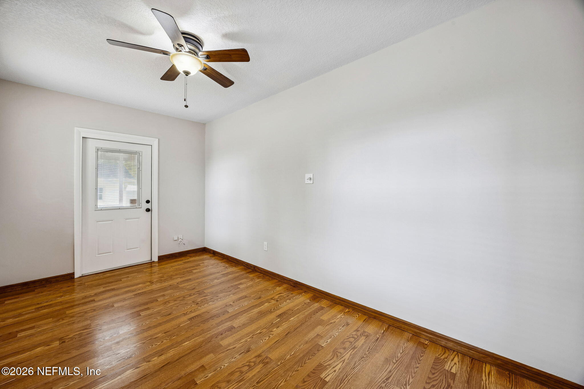 1888 Clemson Road Jacksonville, FL 32217 - Photo 25 of 41 an empty room with wooden floor fan and windows
