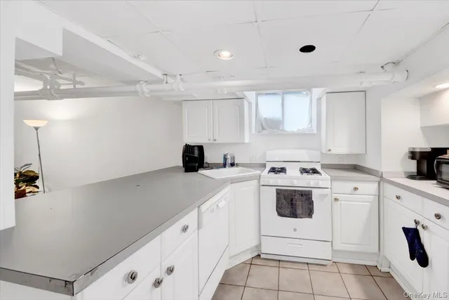 a kitchen with a white cabinets and white appliances