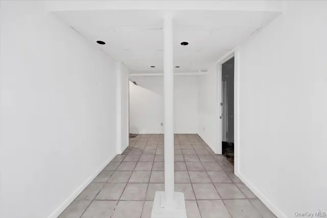 an empty room with a ceiling fan and wooden floor