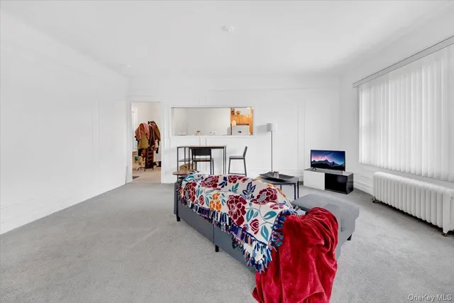 a bedroom with furniture and a window