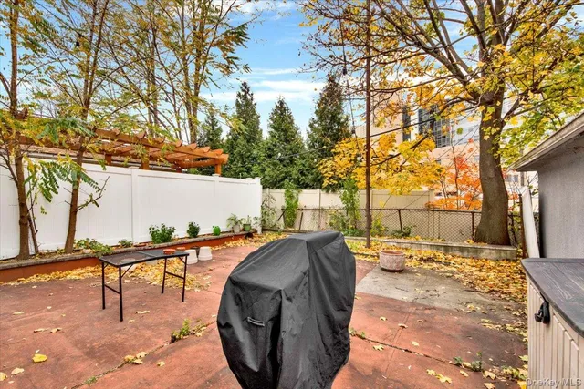 a backyard of a house with barbeque oven
