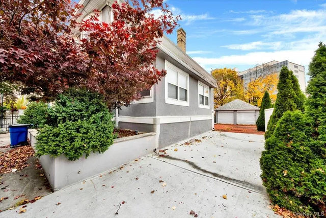 a view of a brick house with large windows