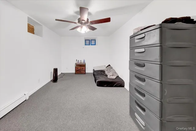a bedroom with a bed and a ceiling fan