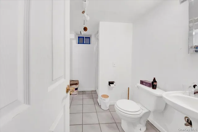 a white toilet sitting next to a bathroom sink