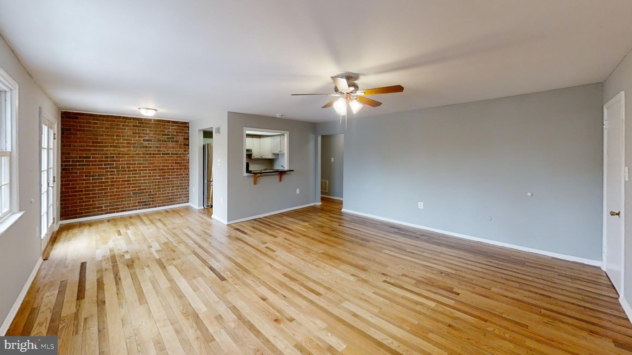 1703 Yardley Commons Yardley, PA 19067 - Photo 11 of 23 a view of empty room with wooden floor and fan