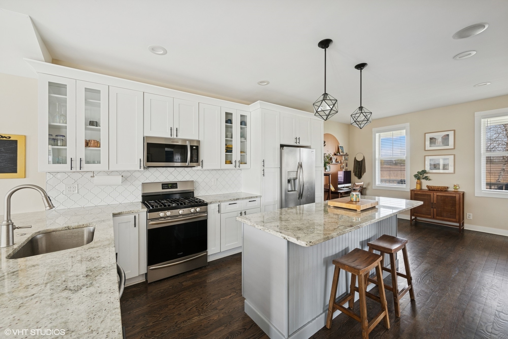 1046 Prairie Trail Grayslake, IL 60030 - Photo 4 of 17 a kitchen with stainless steel appliances granite countertop a stove refrigerator a sink dishwasher a dining table and chairs with wooden floor