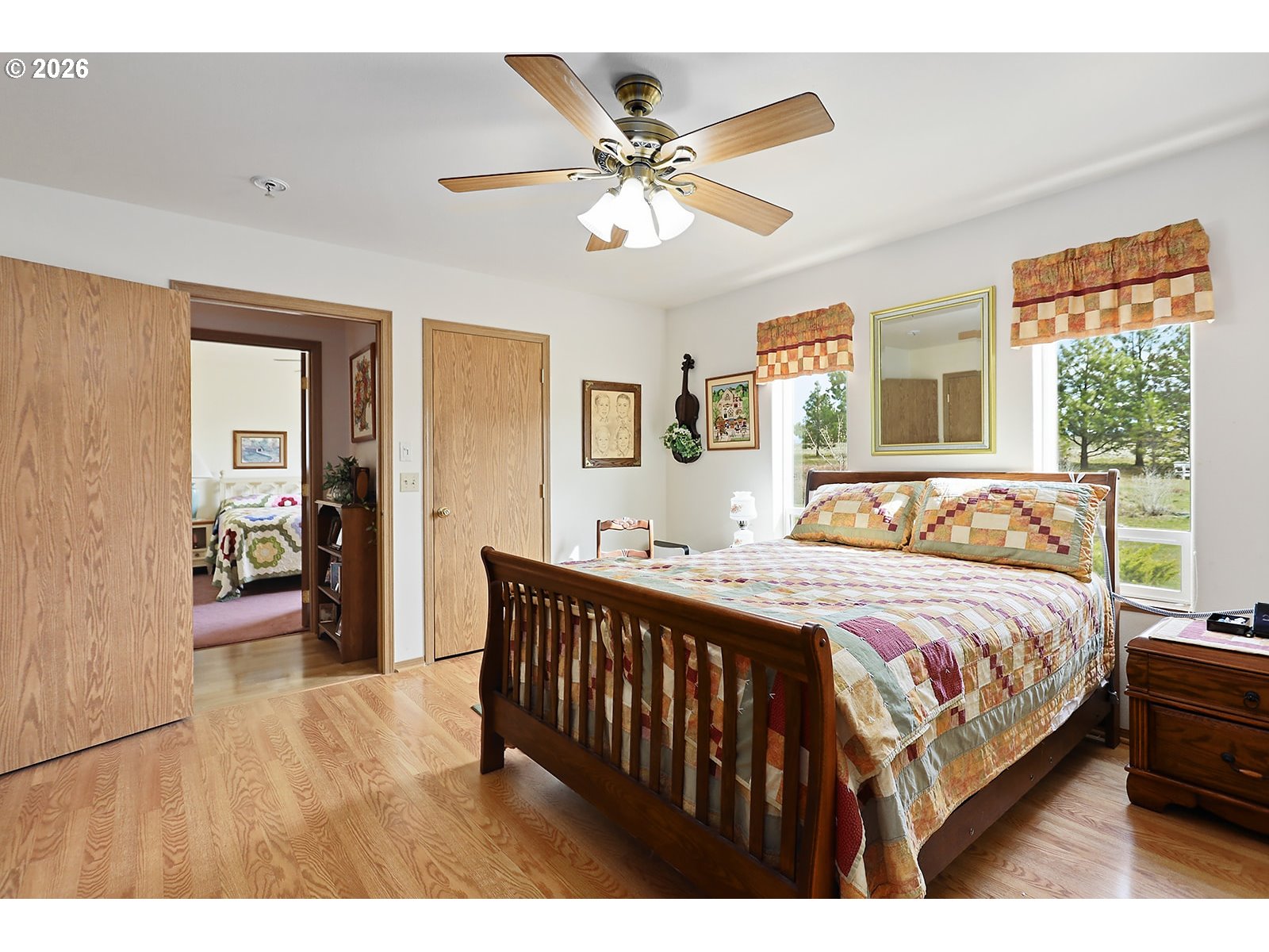 64 Seely Drive Goldendale, WA 98620 - Photo 24 of 46 a bedroom with a bed and a large mirror with a wooden floor