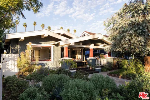 a view of a patio with table and chairs under an umbrella