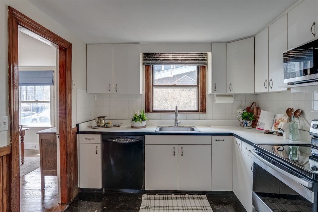 69 Bennett Street Wakefield, MA 01880 - Photo 13 of 27 a kitchen with a sink stove and cabinets