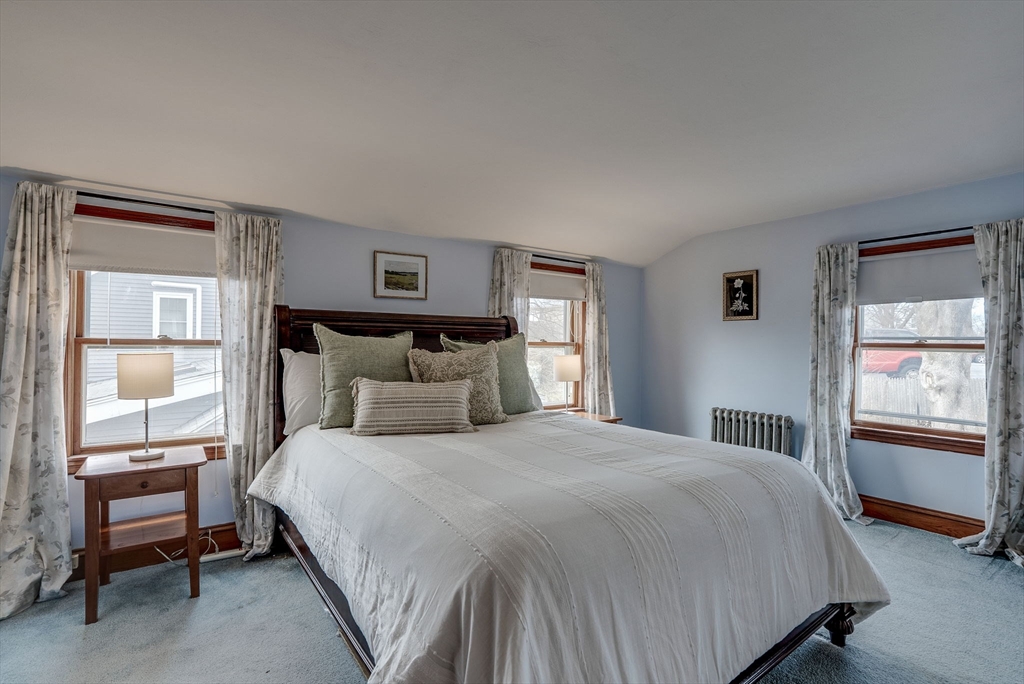 69 Bennett Street Wakefield, MA 01880 - Photo 22 of 27 a bedroom with a bed and a window