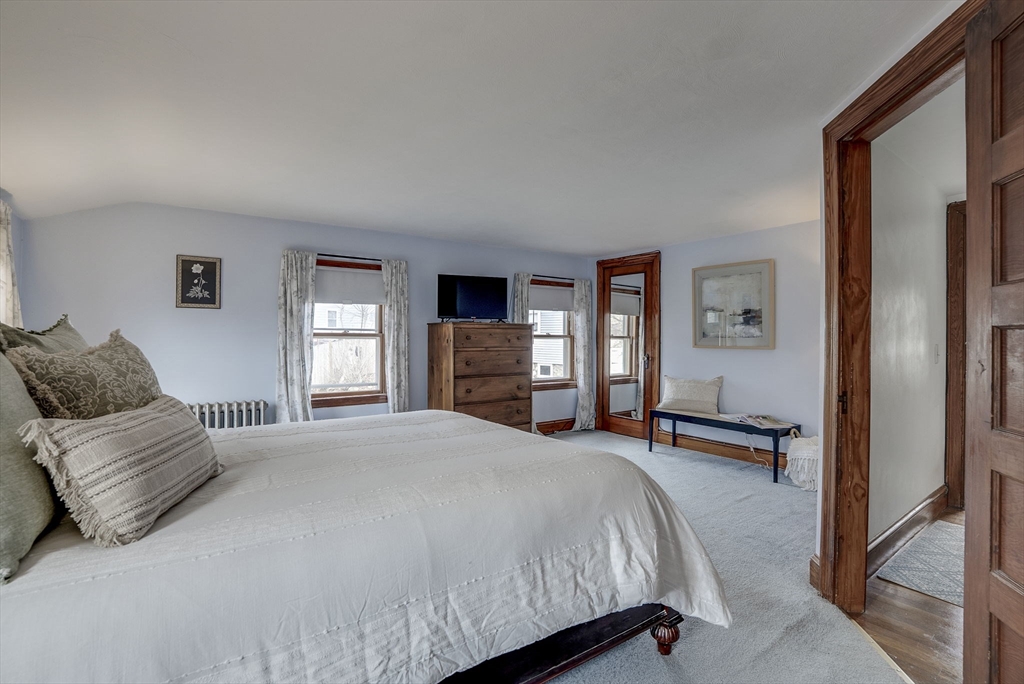 69 Bennett Street Wakefield, MA 01880 - Photo 24 of 27 a bedroom with a bed and dresser with window