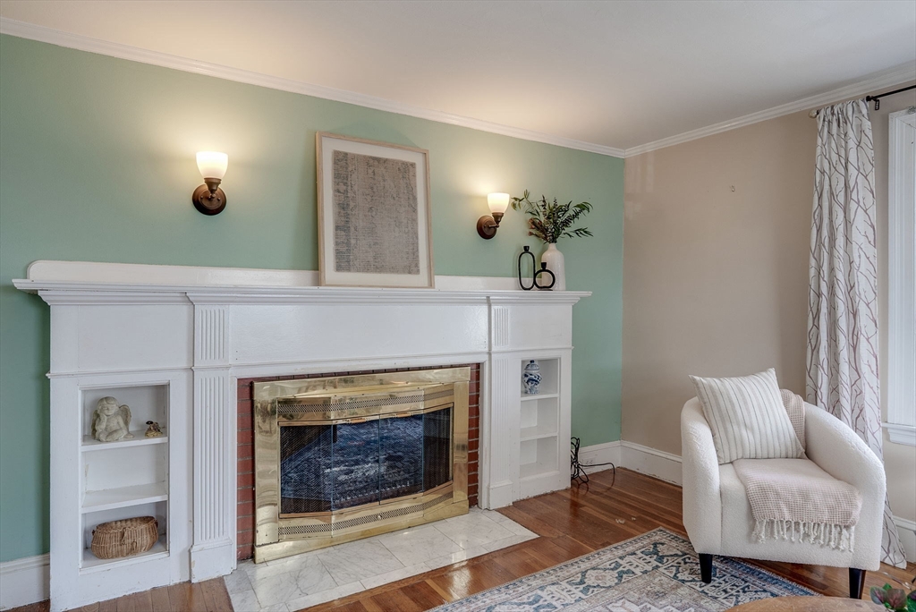 69 Bennett Street Wakefield, MA 01880 - Photo 7 of 27 a living room with furniture and a fireplace
