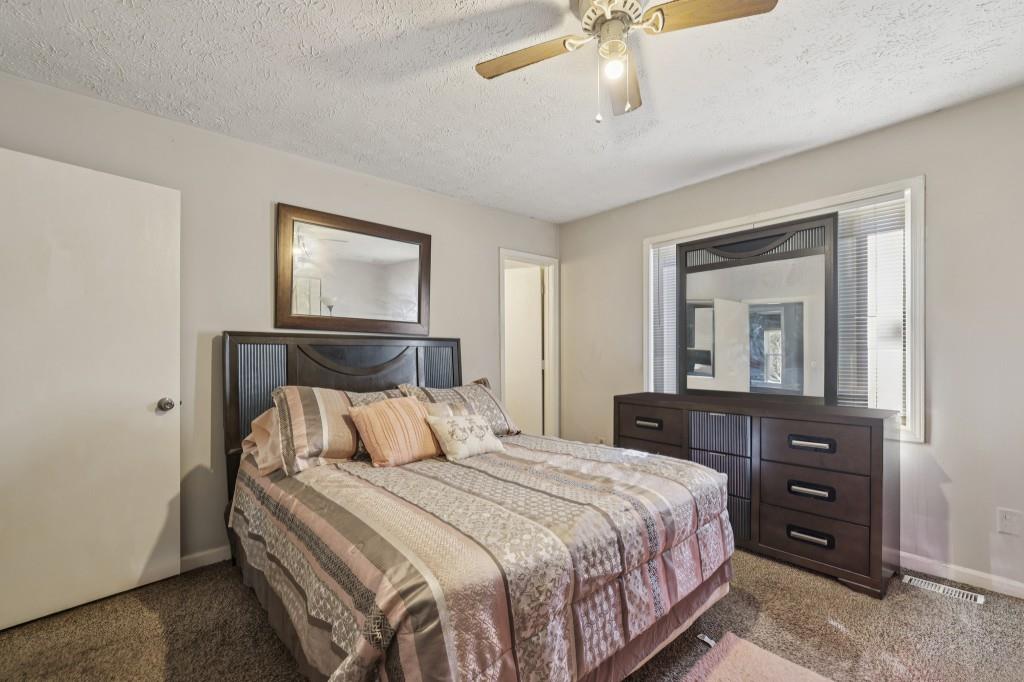 1331 North Hampton Road Alpharetta, GA 30009 - Photo 11 of 41 a bedroom with a bed and a dresser