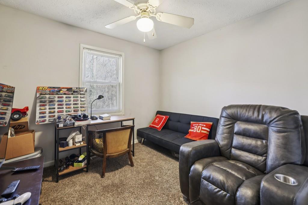 1331 North Hampton Road Alpharetta, GA 30009 - Photo 15 of 41 a living room with furniture a chandelier and a window