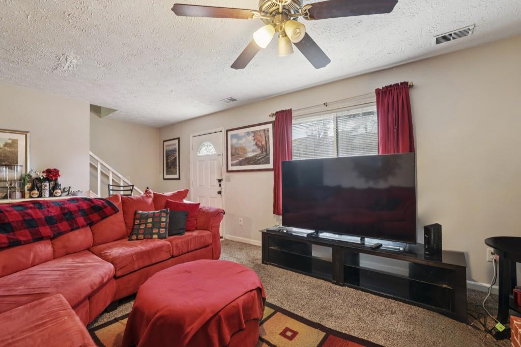 1331 North Hampton Road Alpharetta, GA 30009 - Photo 2 of 41 a living room with furniture and a flat screen tv