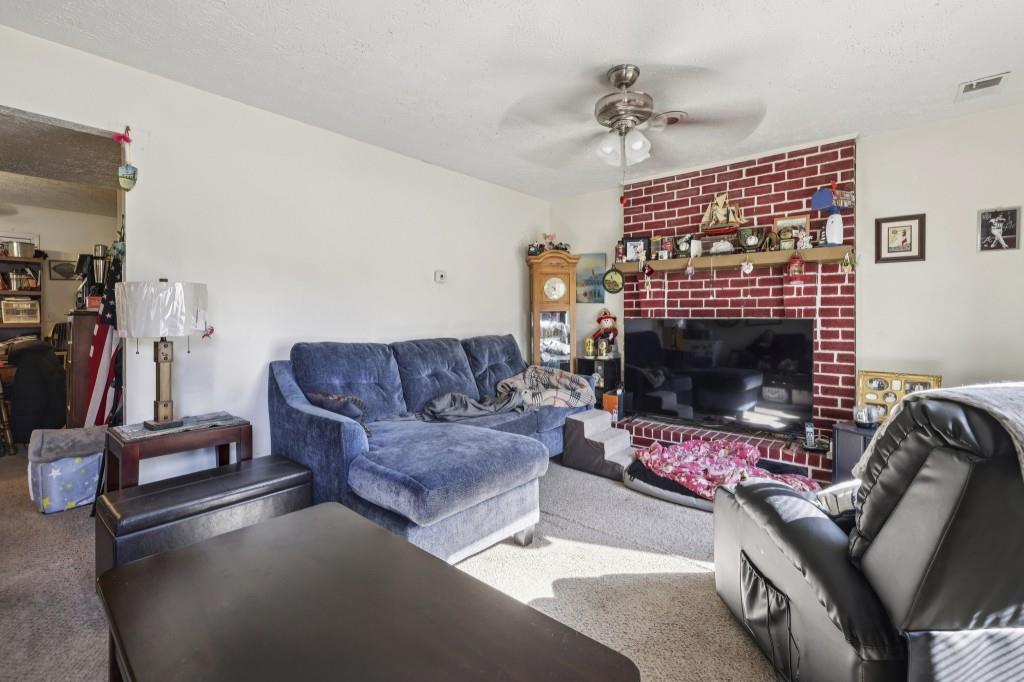 1331 North Hampton Road Alpharetta, GA 30009 - Photo 21 of 41 a living room with furniture a flat screen tv and a fireplace
