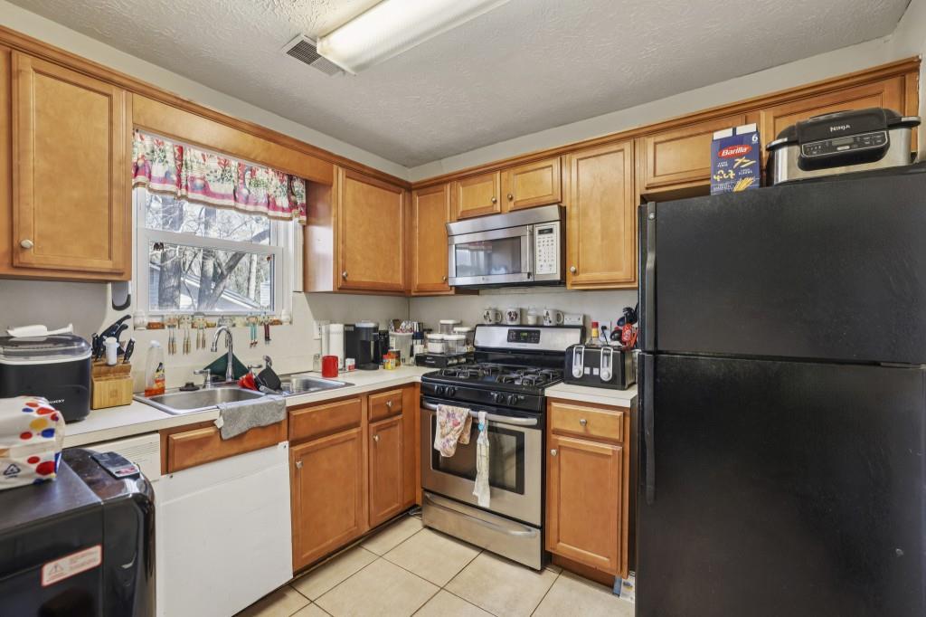 1331 North Hampton Road Alpharetta, GA 30009 - Photo 24 of 41 a kitchen with stainless steel appliances a stove sink refrigerator and window
