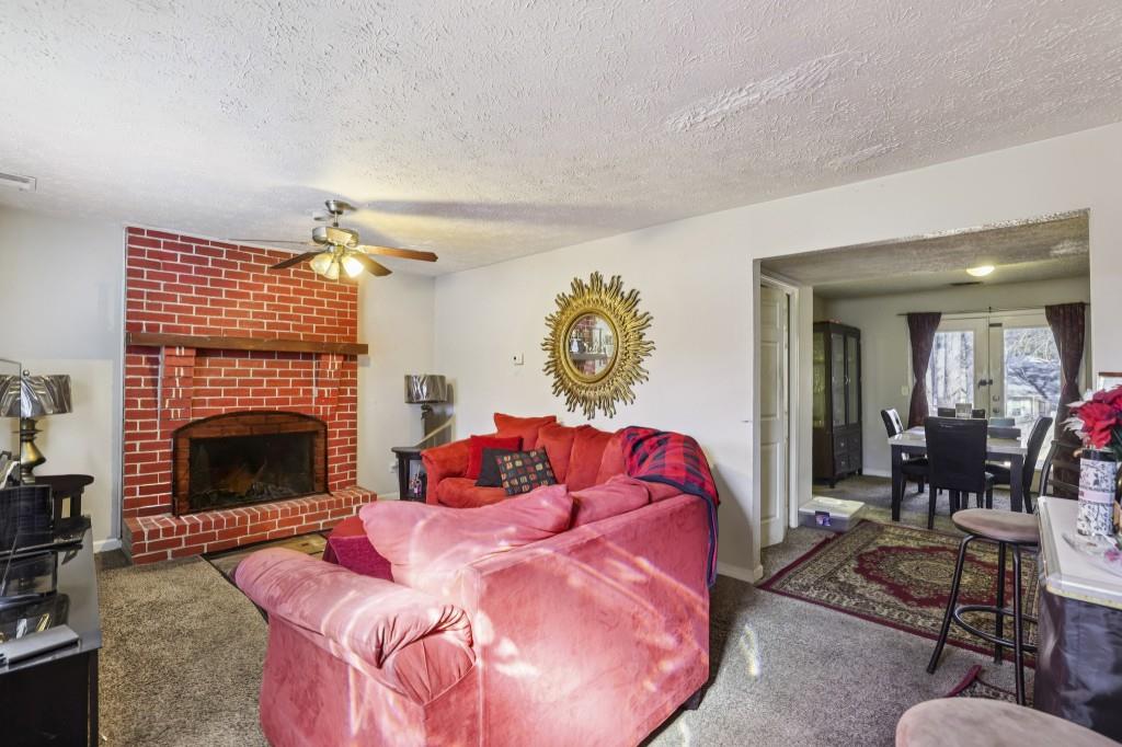 1331 North Hampton Road Alpharetta, GA 30009 - Photo 4 of 41 a living room with furniture and a fireplace