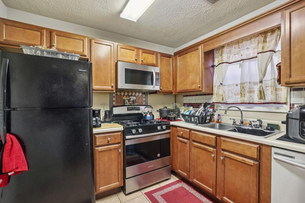 1331 North Hampton Road Alpharetta, GA 30009 - Photo 9 of 41 a kitchen with a sink stove and refrigerator