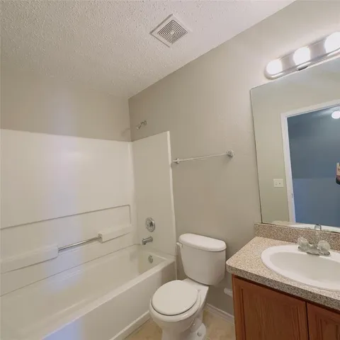 a bathroom with a sink a toilet and a bathtub