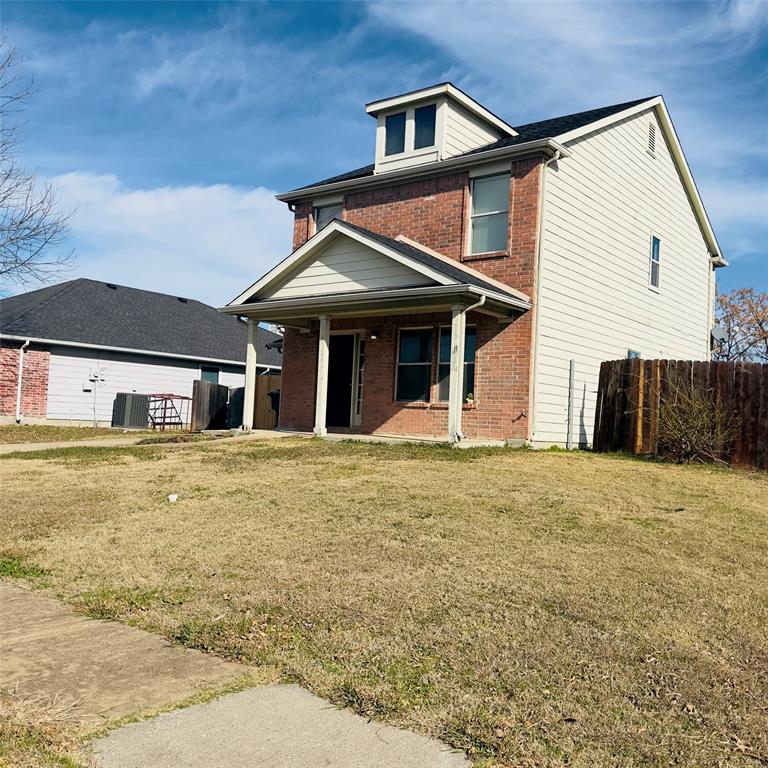 1414 Hardned Lane Dallas, TX 75217 - Photo 2 of 13 a front view of a house with a yard