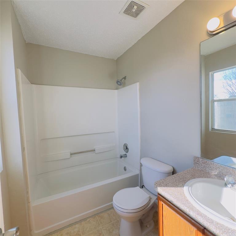 1414 Hardned Lane Dallas, TX 75217 - Photo 8 of 13 a white toilet sitting next to a bath tub
