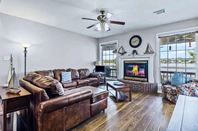 a living room with furniture a fireplace and a large window