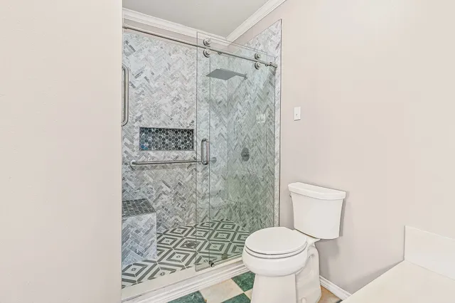 a bathroom with a double vanity sink mirror and toilet