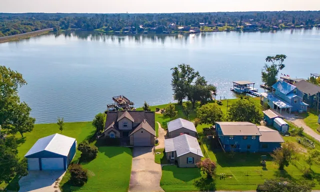 an aerial view of a house with a lake view
