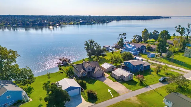 an aerial view of a house with a lake view