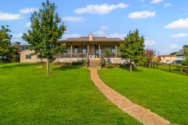a view of a house with a yard and sitting area