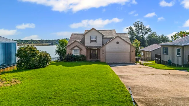 a front view of a house with a yard table and chairs