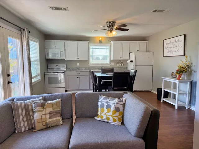 a view of a house with backyard and sitting area