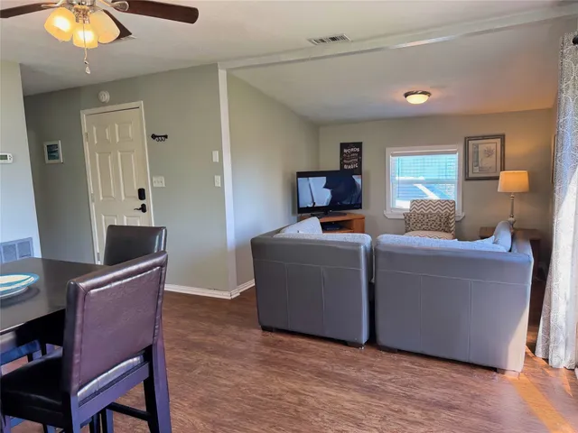 a kitchen with a table chairs sink and cabinets