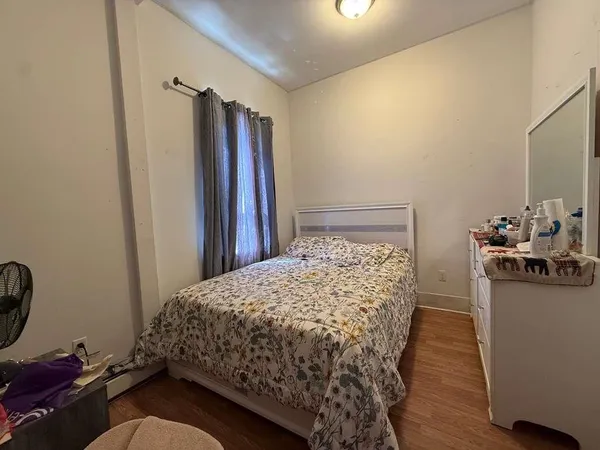 a bedroom with a bed and a mirror